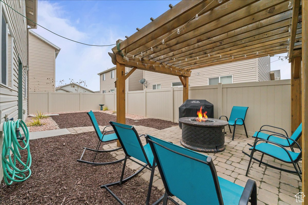 View of patio / terrace featuring a pergola and a fire pit