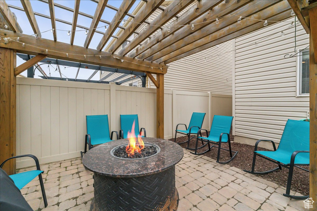 View of terrace featuring an outdoor fire pit and a pergola