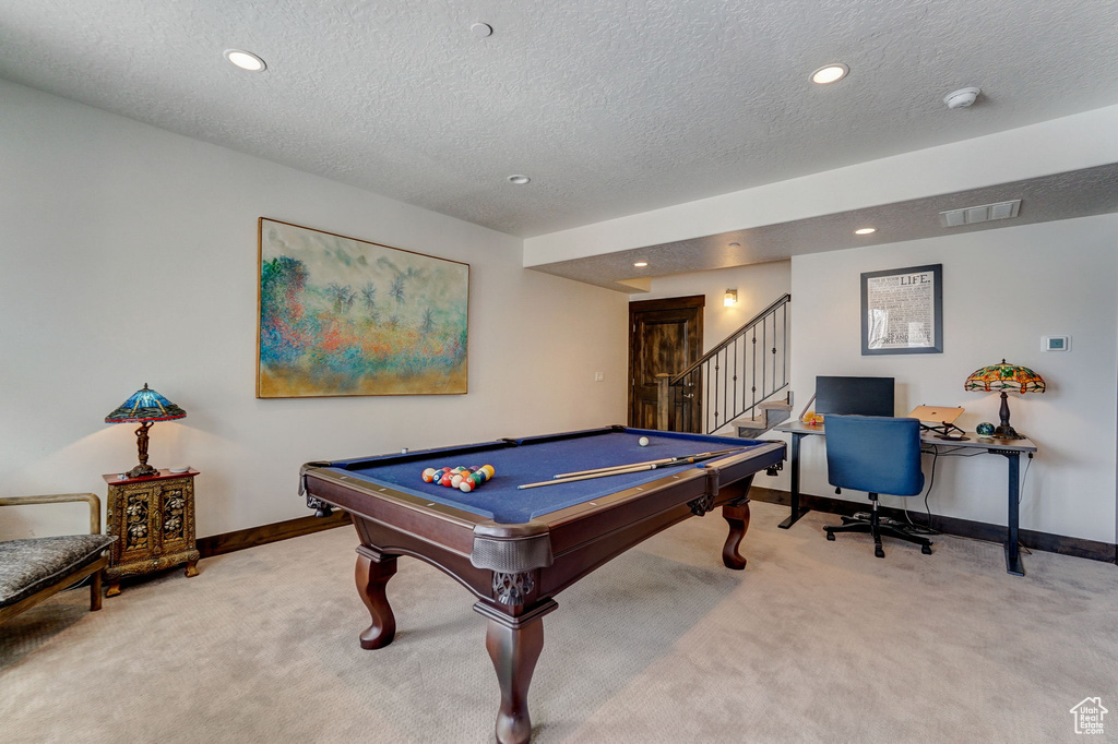 Playroom with light colored carpet, a textured ceiling, and pool table