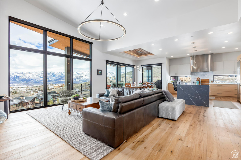 Living room with a mountain view, light hardwood / wood-style floors, and sink