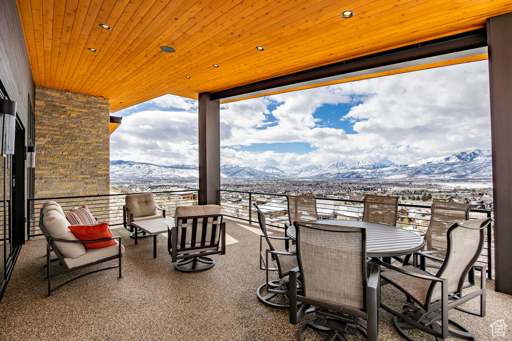 View of terrace with a mountain view, an outdoor living space, and a balcony