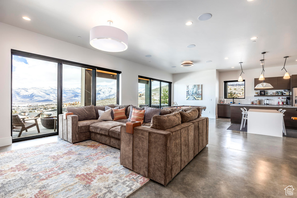Living room featuring a mountain view and concrete floors