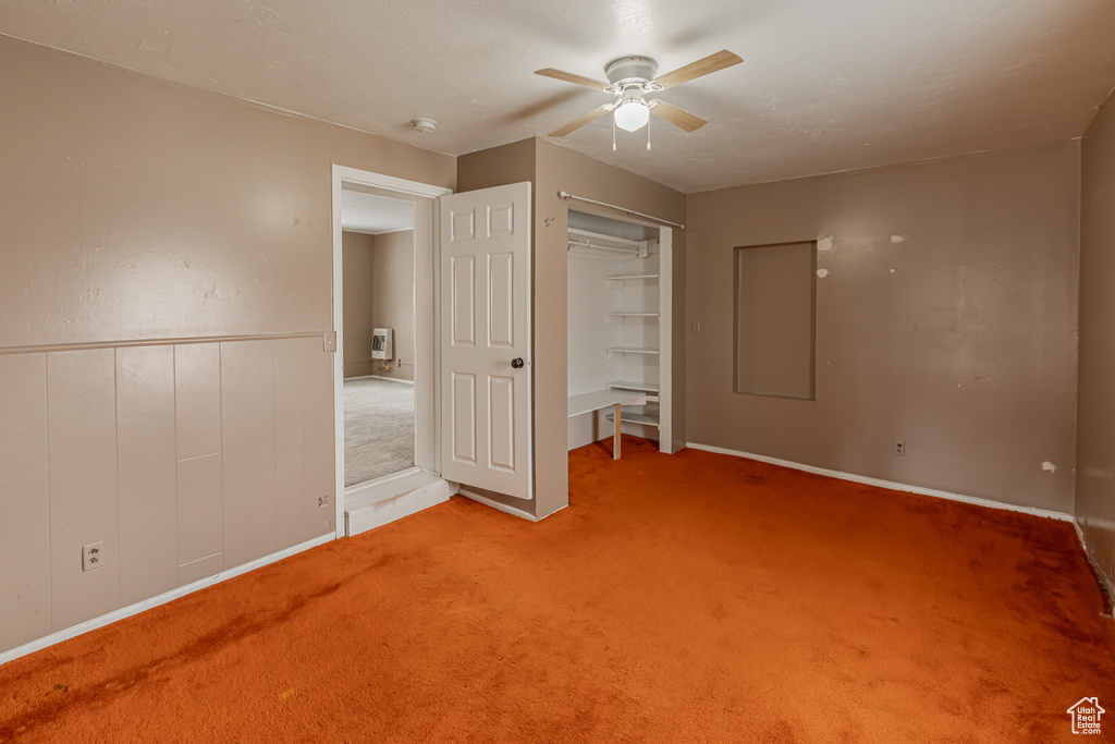 Unfurnished bedroom with carpet flooring, ceiling fan, and a closet