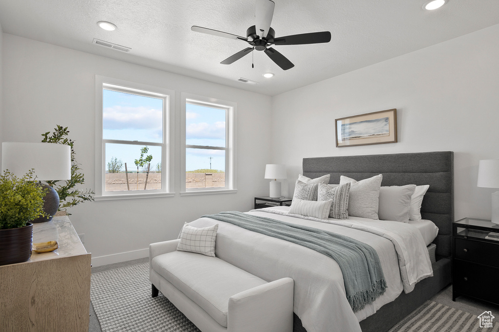 Bedroom featuring light carpet and ceiling fan