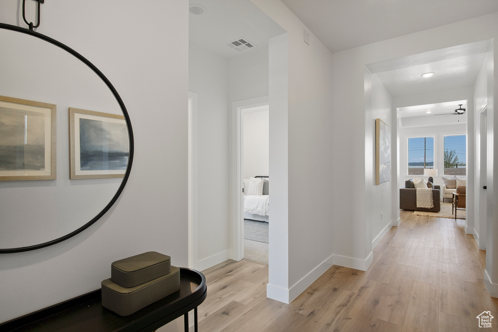 Hallway with light hardwood / wood-style floors