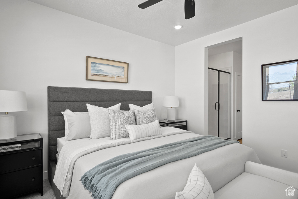 Carpeted bedroom featuring ceiling fan