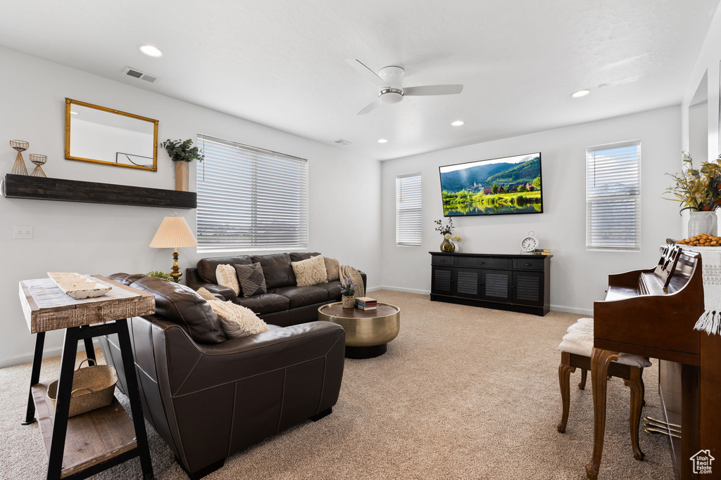Living room with light carpet and ceiling fan
