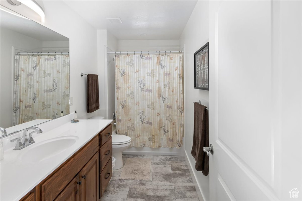 Bathroom featuring tile floors, toilet, and oversized vanity