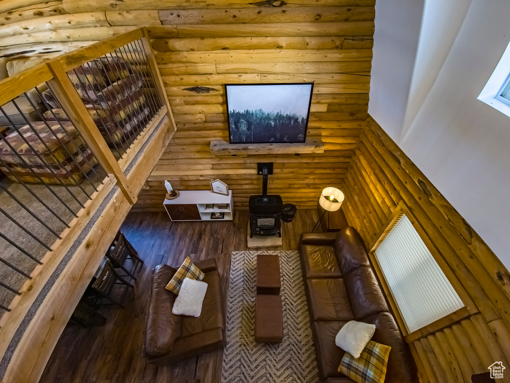 Living room featuring log walls and dark hardwood / wood-style floors