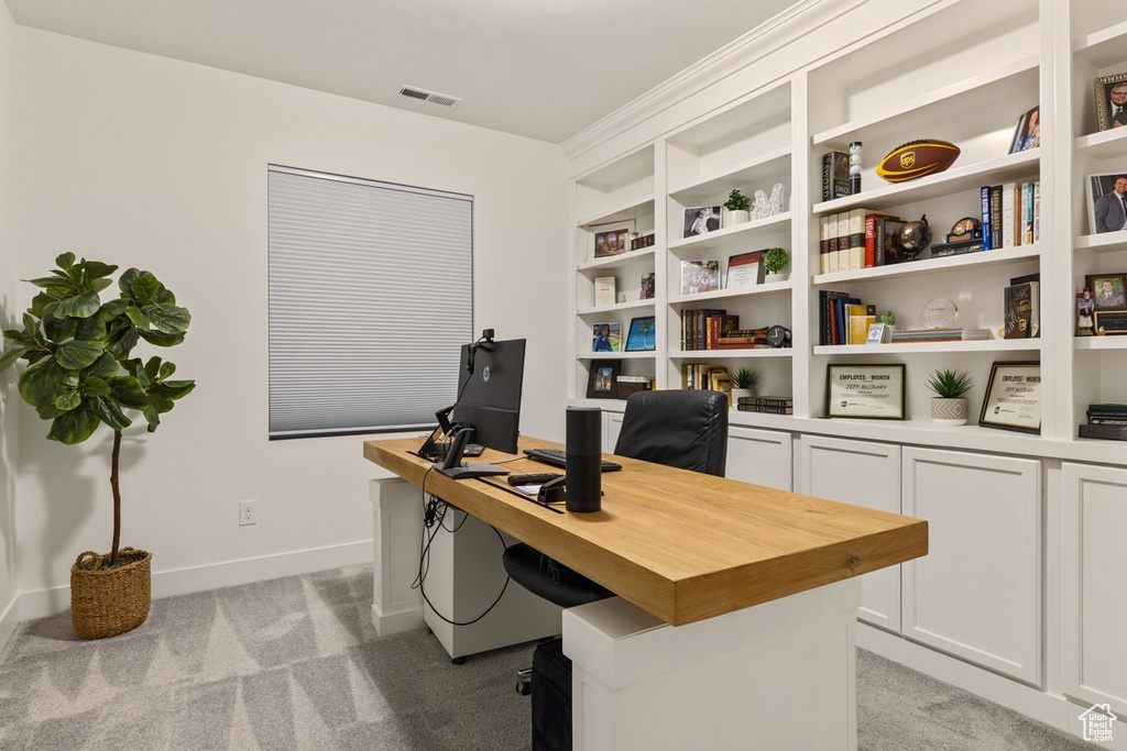 Carpeted office featuring built in features
