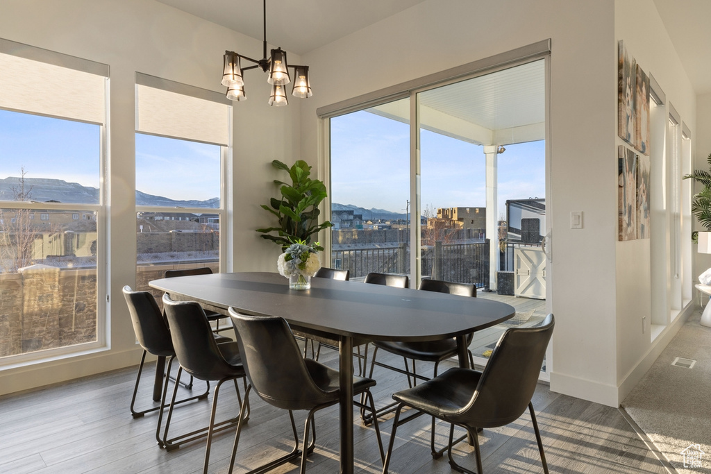 Dining space featuring a chandelier, a mountain view, and light hardwood / wood-style floors