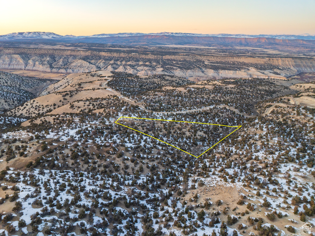 Aerial view at dusk featuring a mountain view