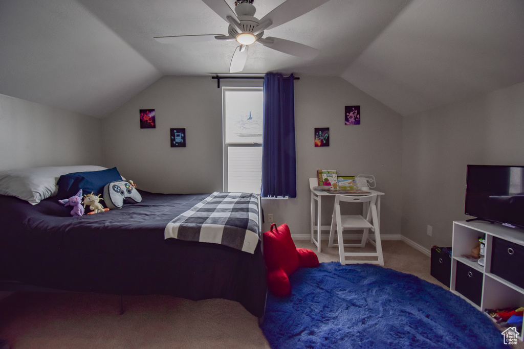Bedroom featuring vaulted ceiling, carpet floors, and ceiling fan