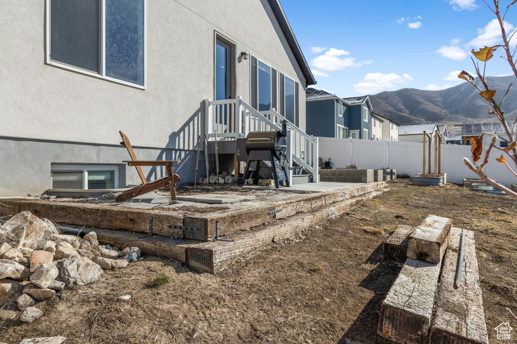 Rear view of house with a patio area and a mountain view