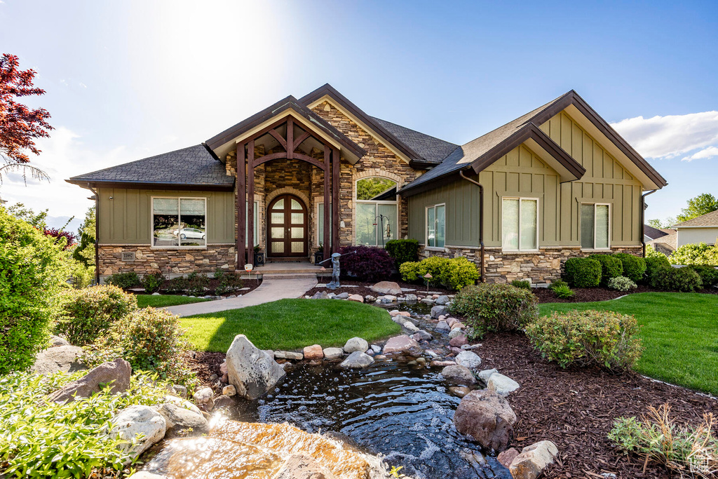 Craftsman inspired home with a front yard