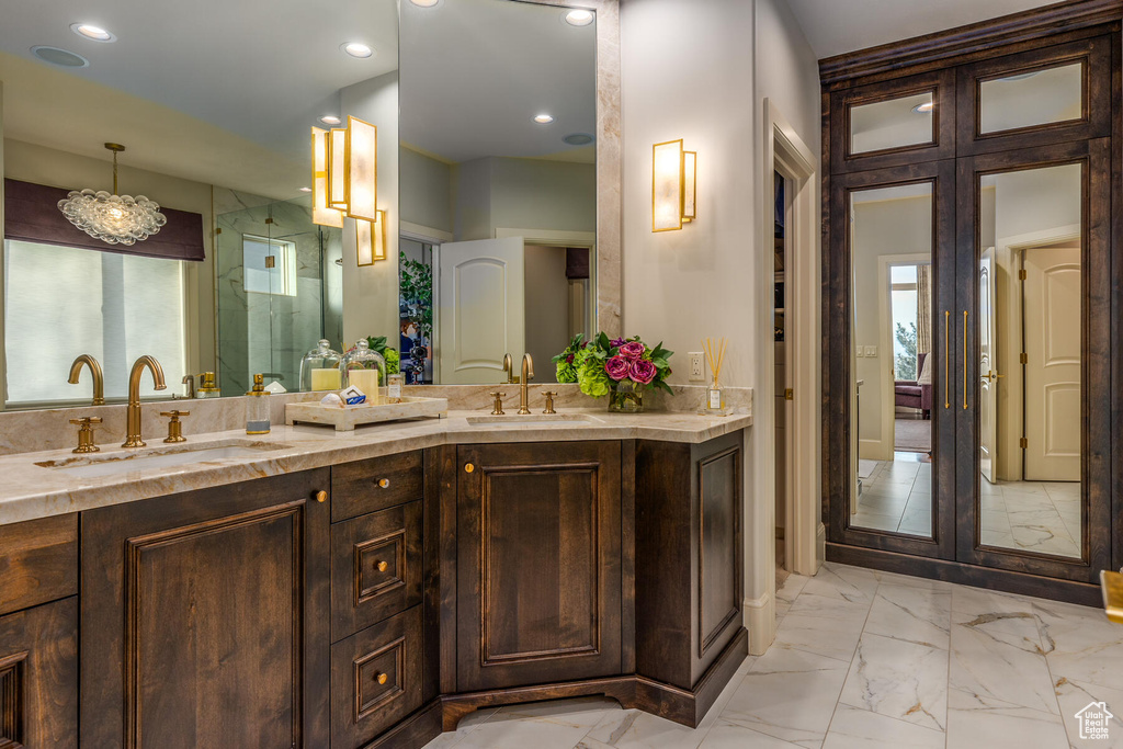 Bathroom with tile flooring, dual sinks, and vanity with extensive cabinet space