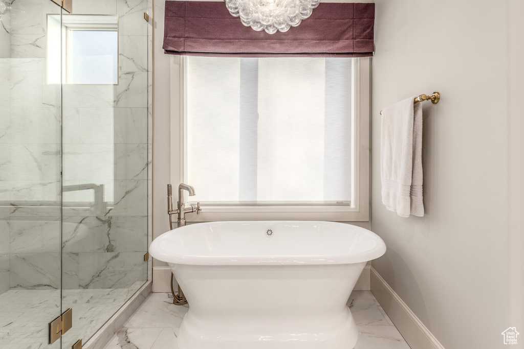 Bathroom with tile flooring and independent shower and bath