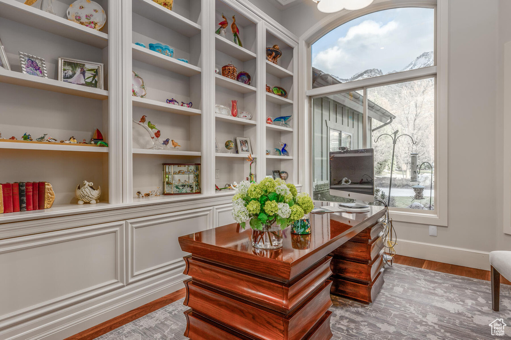 Office space with plenty of natural light and light hardwood / wood-style flooring