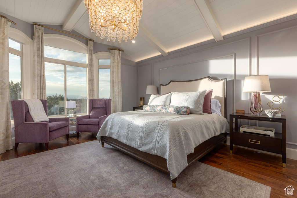 Bedroom featuring vaulted ceiling with beams, dark wood-type flooring, and a chandelier