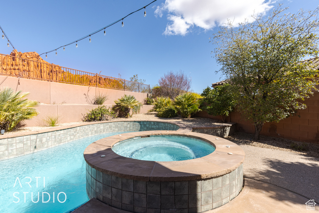 View of pool featuring an in ground hot tub