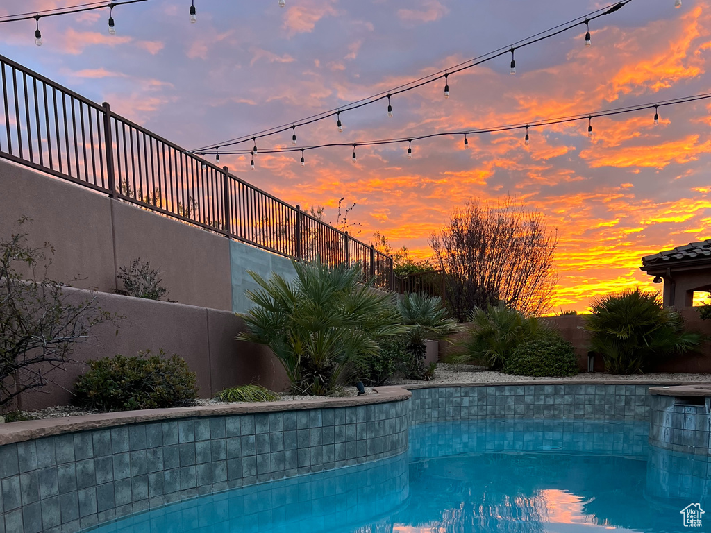View of pool at dusk