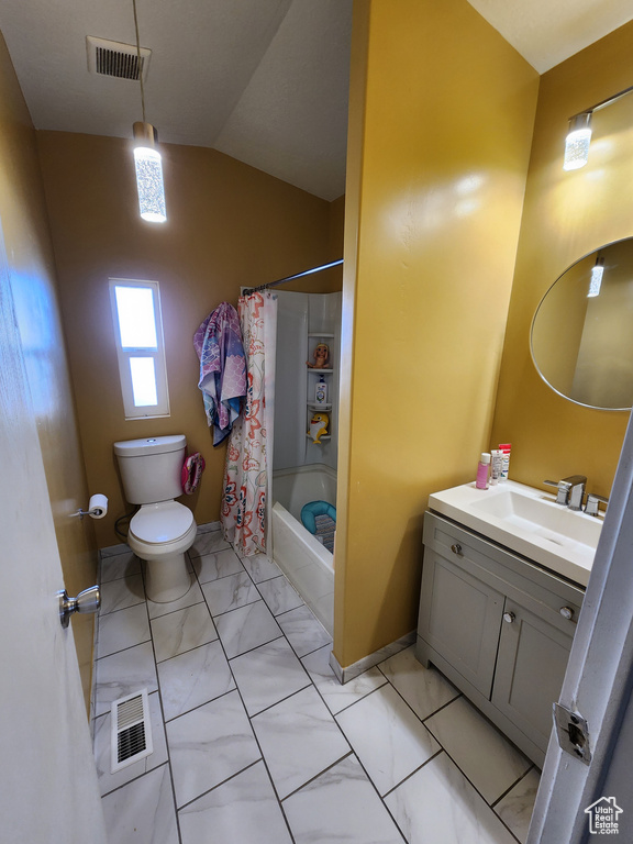 Full bathroom featuring vanity, vaulted ceiling, toilet, shower / bathtub combination with curtain, and tile floors