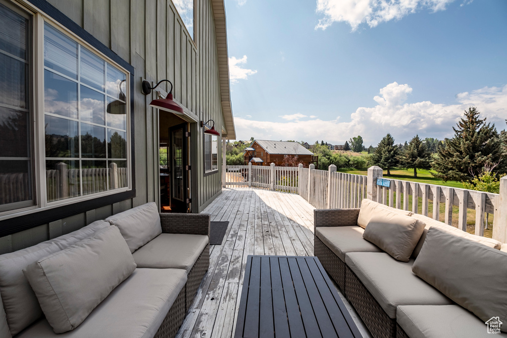 Wooden deck featuring outdoor lounge area