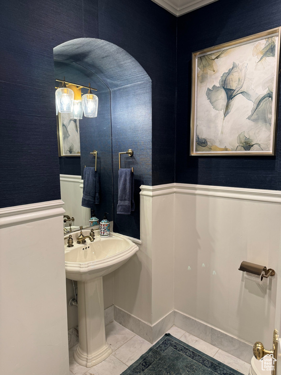 Bathroom featuring tile flooring and crown molding