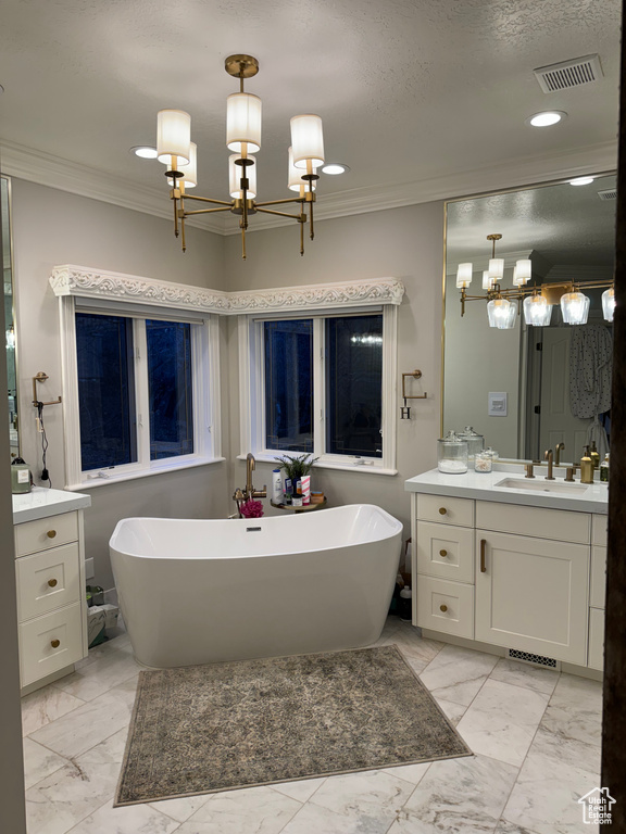 Bathroom with a notable chandelier, oversized vanity, tile flooring, and a textured ceiling