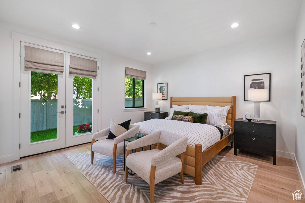 Bedroom featuring french doors, access to outside, and light hardwood / wood-style floors