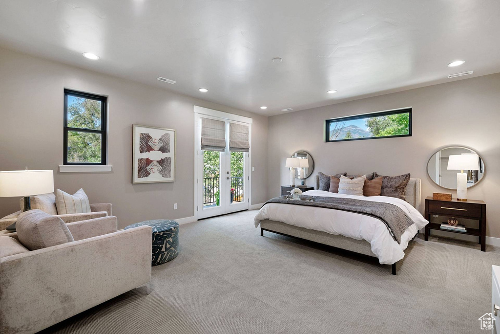 Bedroom featuring french doors, light carpet, and access to outside