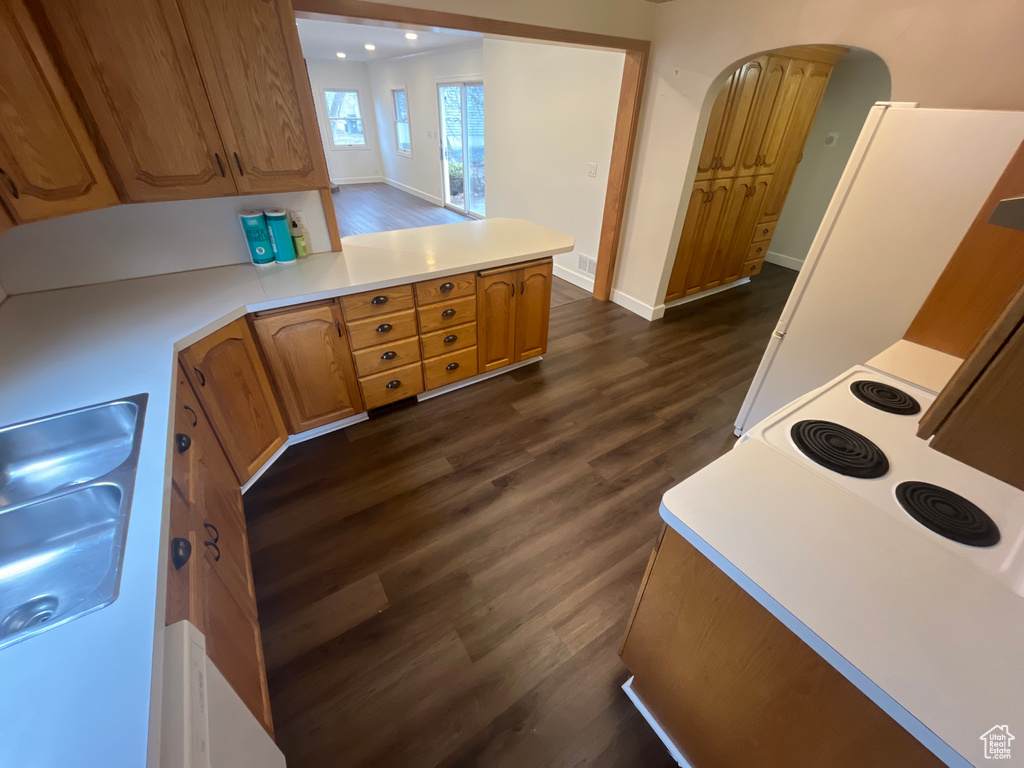 Kitchen featuring dark hardwood / wood-style floors, white refrigerator, and sink