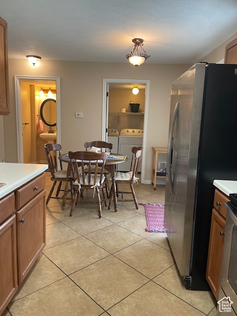 Dining area featuring light tile floors and washer and clothes dryer