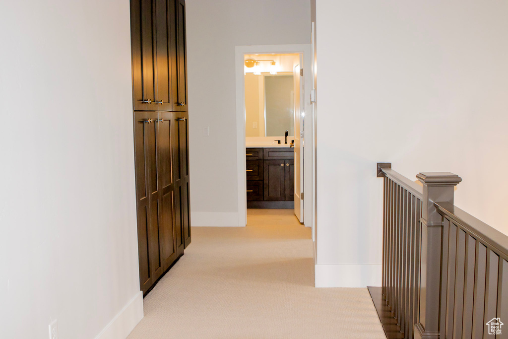 Hall featuring light carpet and sink