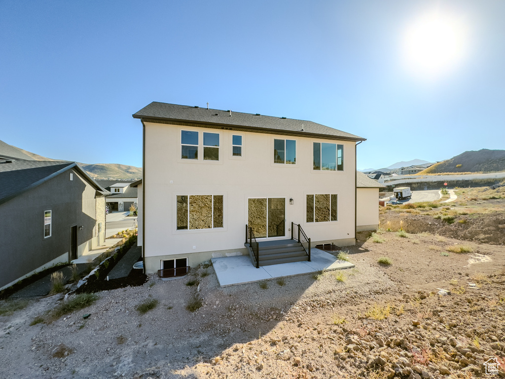 Rear view of property with a mountain view