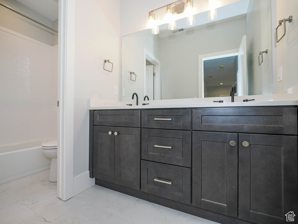 Full bathroom featuring shower / washtub combination, toilet, tile flooring, and dual vanity