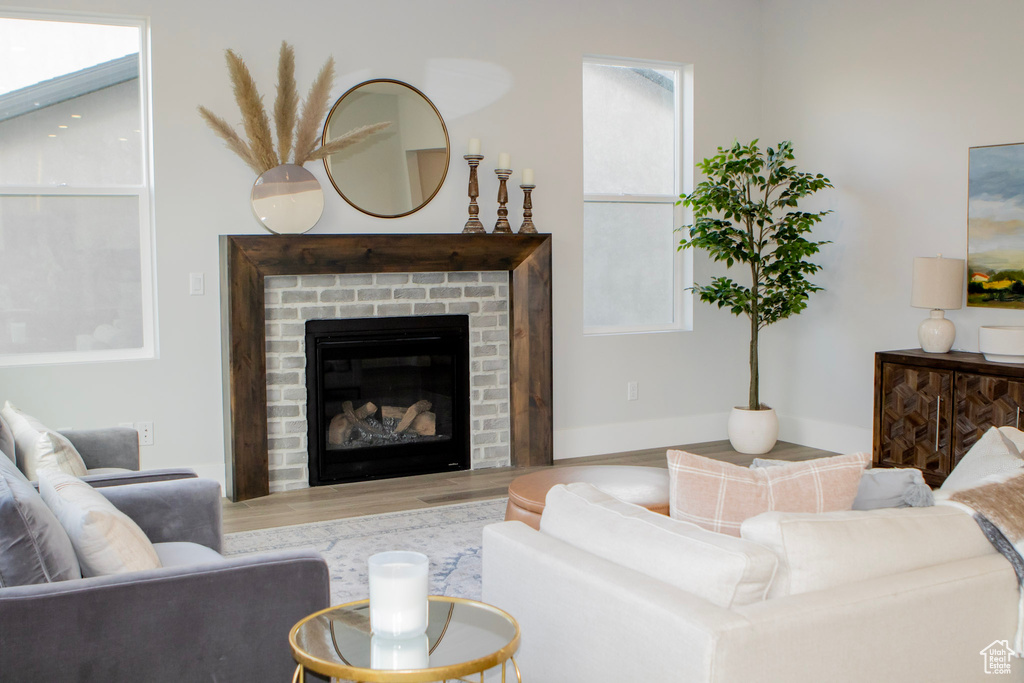 Living room with a fireplace and hardwood / wood-style flooring