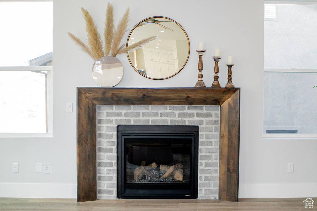 Interior details featuring a fireplace and wood-type flooring