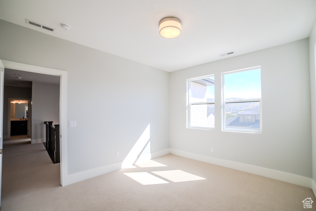 Empty room with light colored carpet