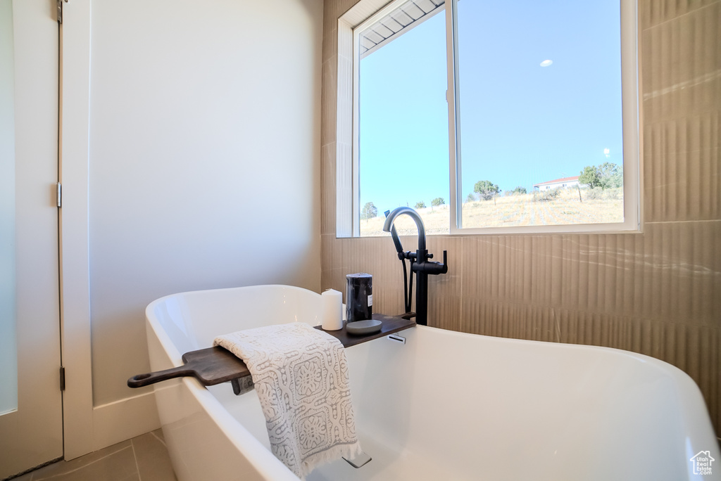 Interior space with a bathtub and tile patterned floors