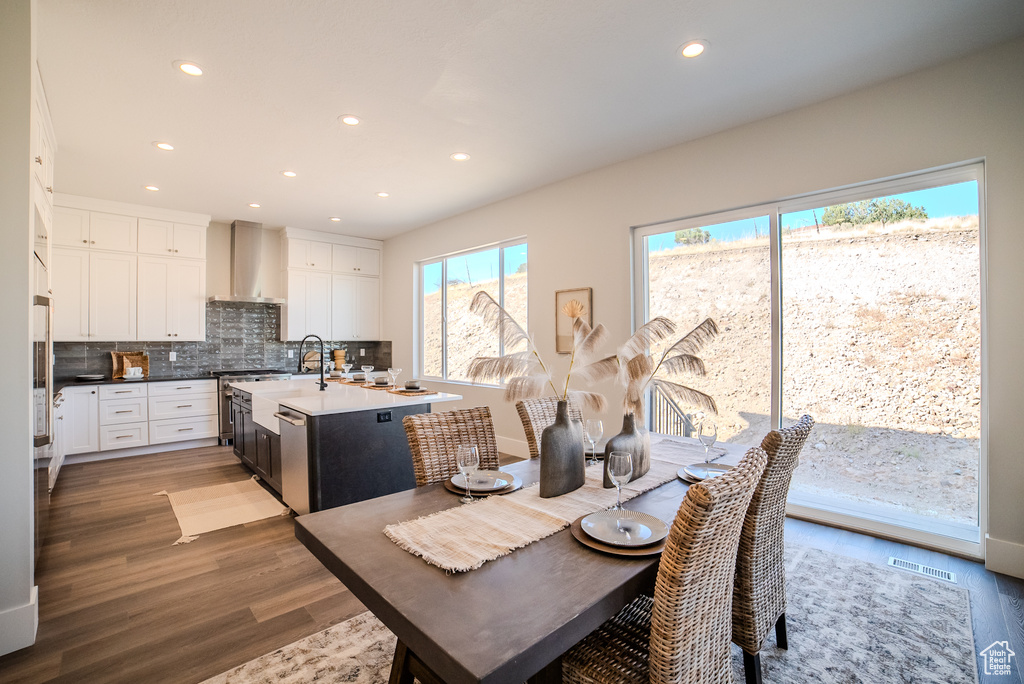 Dining area with sink and hardwood / wood-style floors