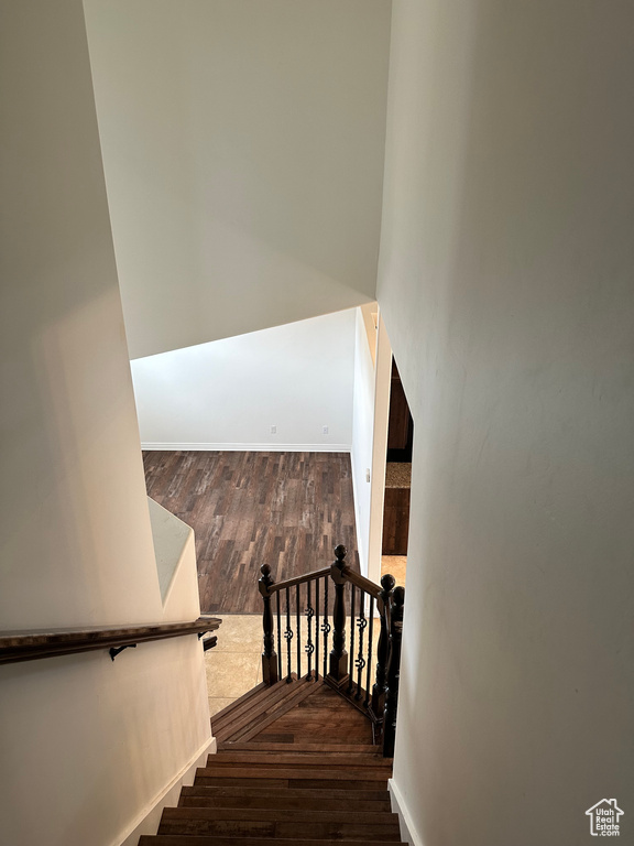 Stairway featuring dark wood-type flooring