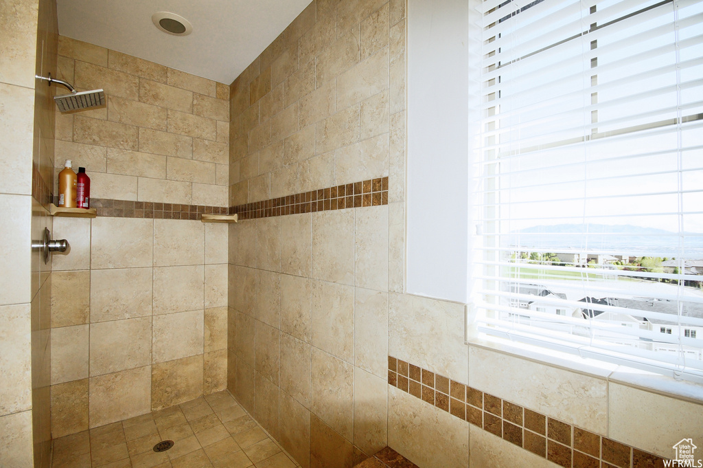 Bathroom featuring a tile shower and a mountain view