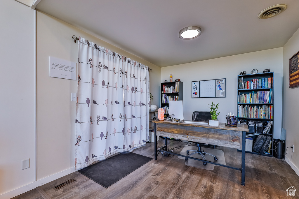 Office space with dark wood-type flooring