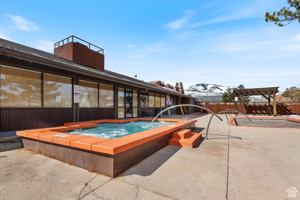 View of swimming pool with a mountain view, a pergola, an in ground hot tub, and a patio area