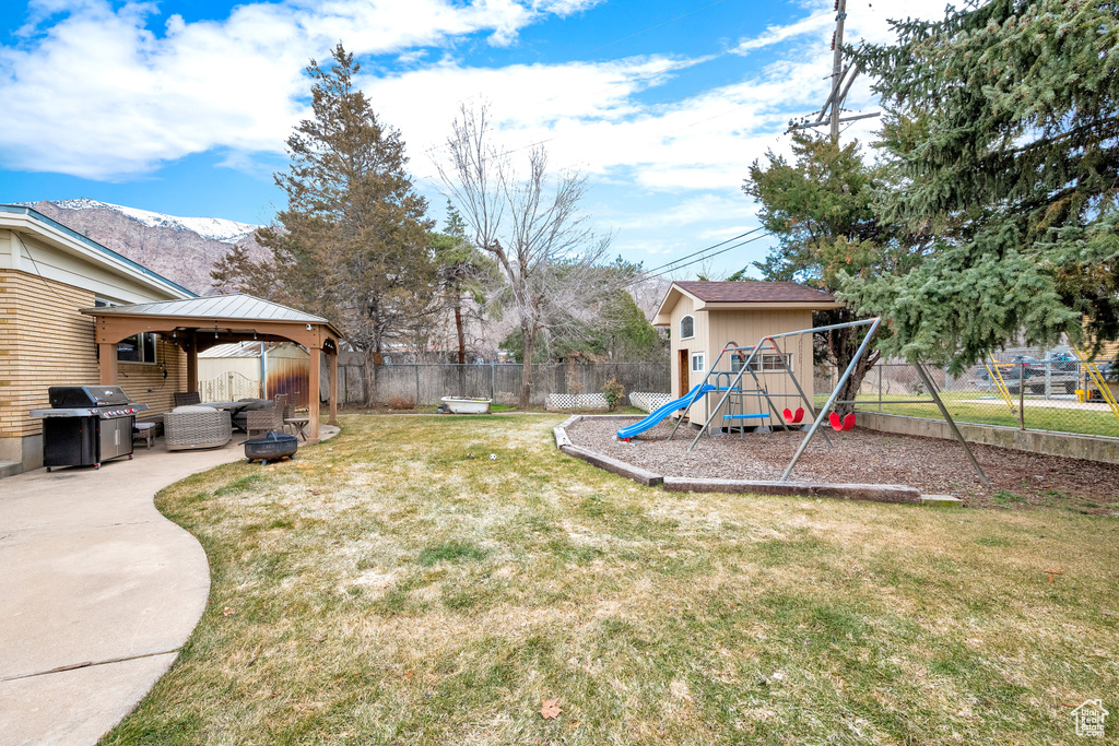 View of yard with a mountain view, a playground, a patio area, and a gazebo