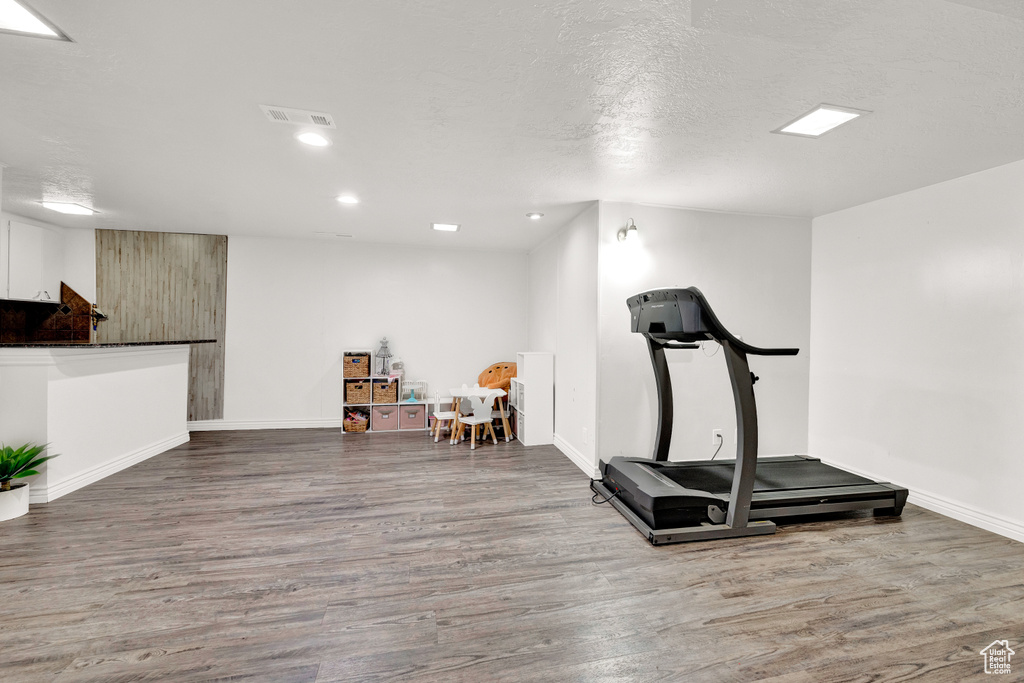 Workout area featuring hardwood / wood-style floors