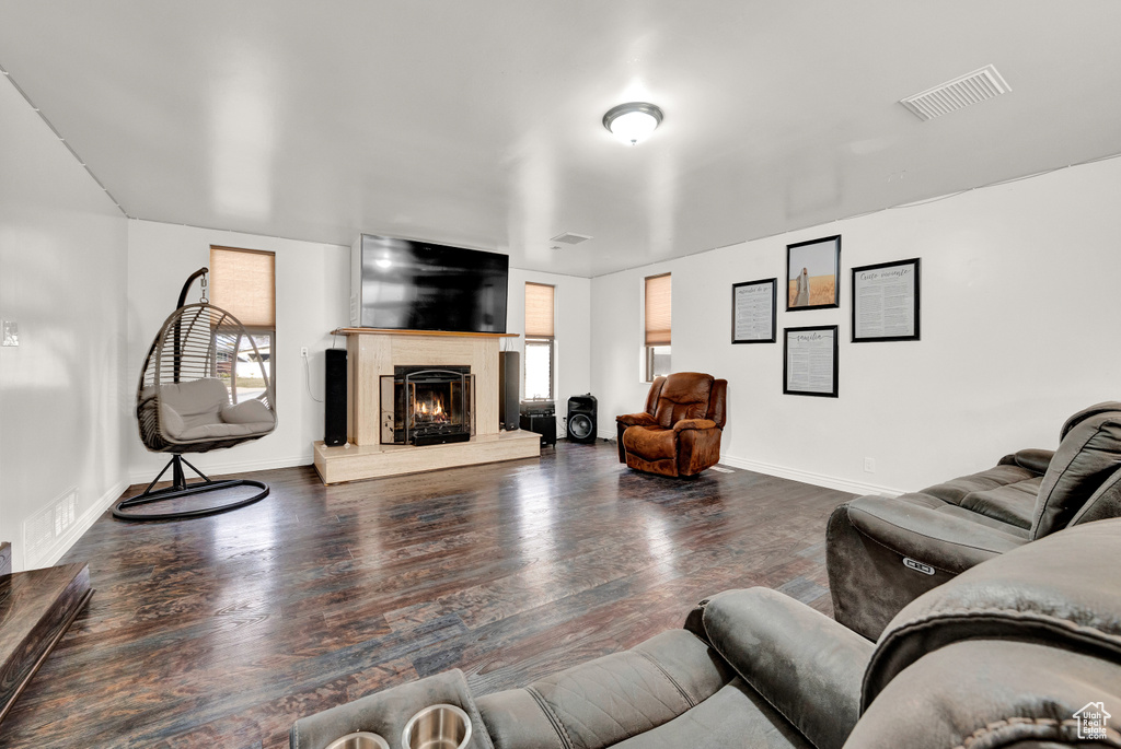 Living room featuring dark hardwood / wood-style flooring and plenty of natural light
