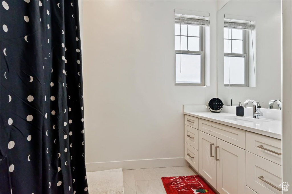 Bathroom featuring tile flooring and vanity