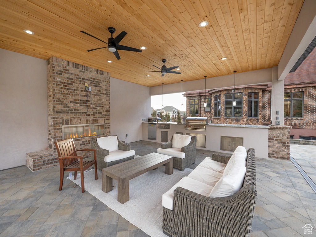 View of patio / terrace with outdoor lounge area, an outdoor kitchen, ceiling fan, and grilling area